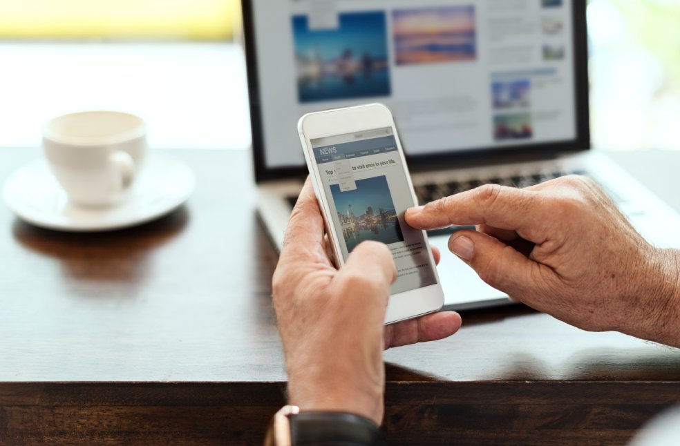 Elderly man reading news through Social Media