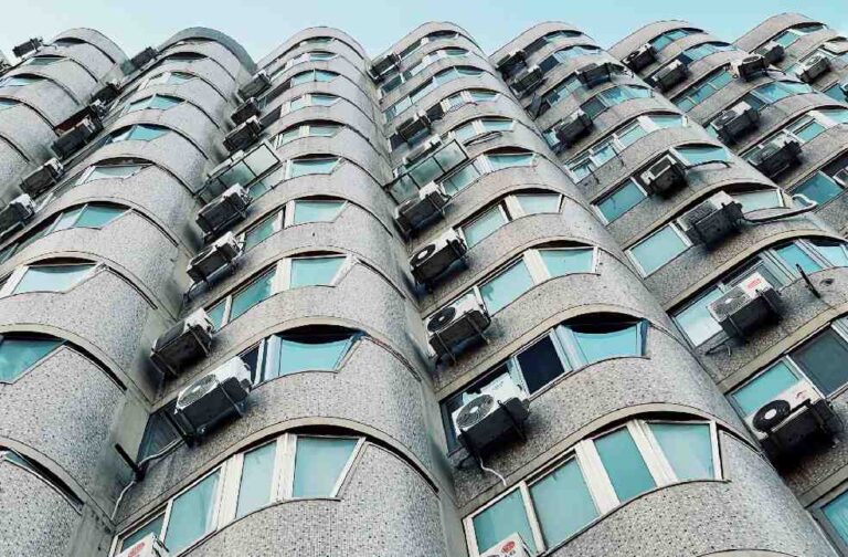 Europe heatwave boosts demand for Chinese AC units spike Low angle view of a modern apartment building facade in Beijing, showcasing its unique architecture