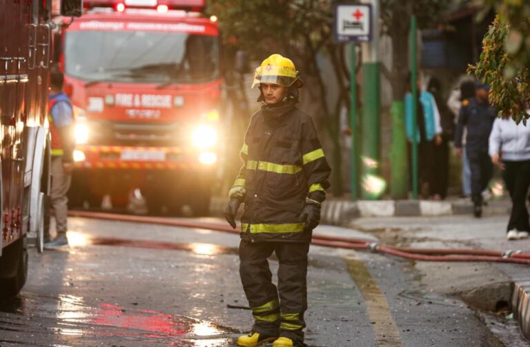 11 killed in fire at foster care facility in Algiers Firefighter in uniform stands near a fire truck in the street during an emergency operation