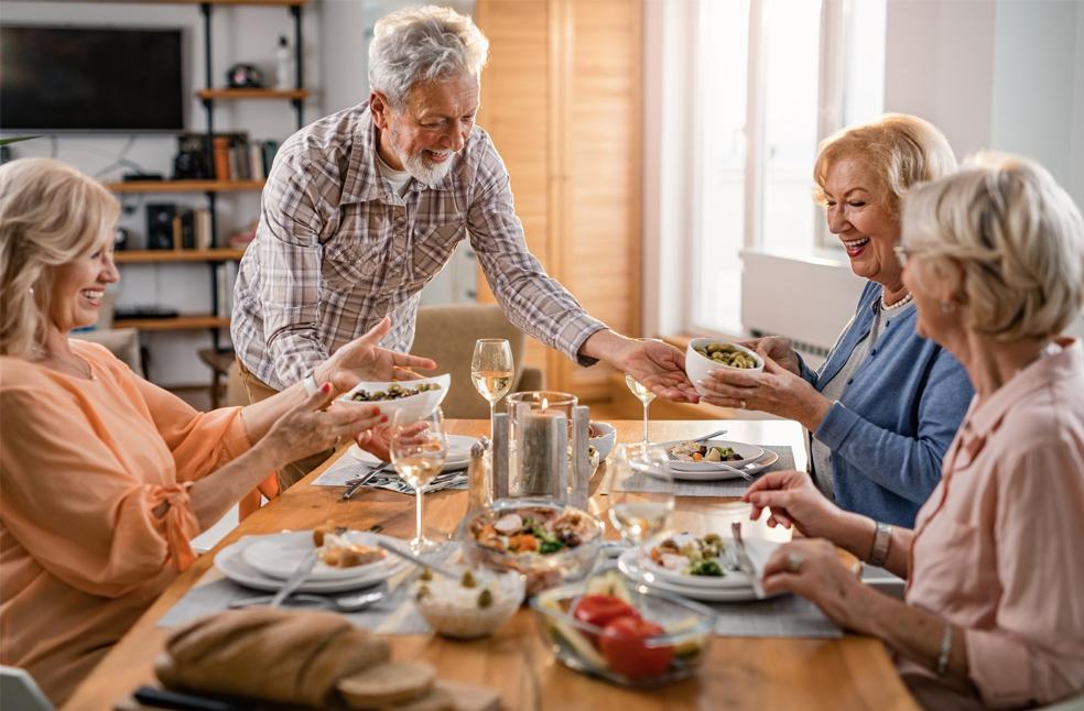 Group of old people eating food