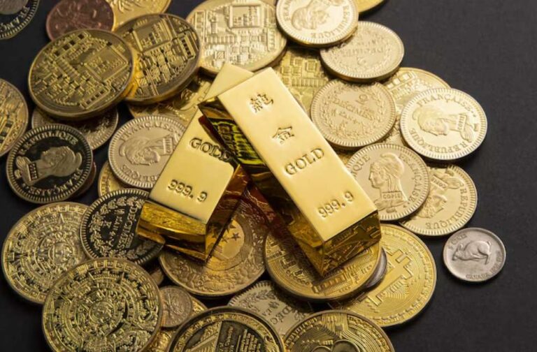 EU bans gold imports from Sudan over war concerns Coins, and gold bars scattered on a table