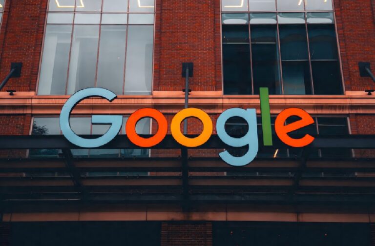 Google growth overshadowed by rising AI investment costs Colorful Google logo on modern building exterior in urban environment.