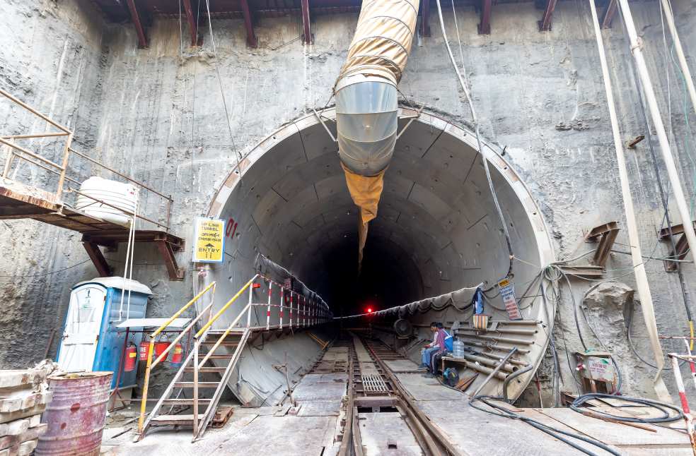 Industrial tunnel entrance under construction with heavy machinery