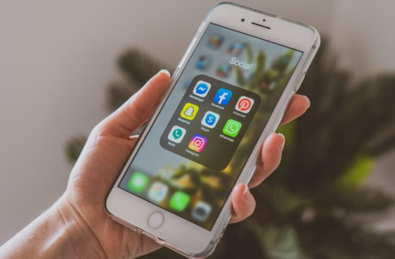 France moves closer to social media ban for children Close-up of a hand holding a smartphone displaying popular social media apps