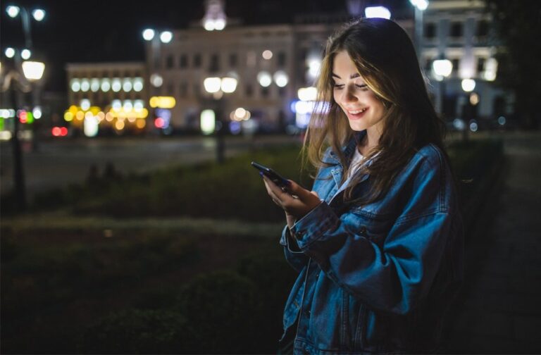 UK plans default overnight social media curfew for teens A teenager using a phone at night outdoors