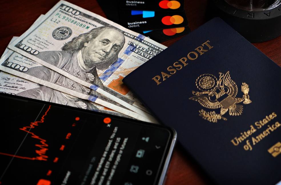 US passport with hundred-dollar bills