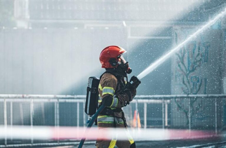 Massive Norway wildfire destroys over 100 homes A brave firefighter operates a fire hose