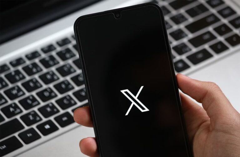 Fake X login emails target users in sophisticated scam A hand holds a smartphone displaying the X app