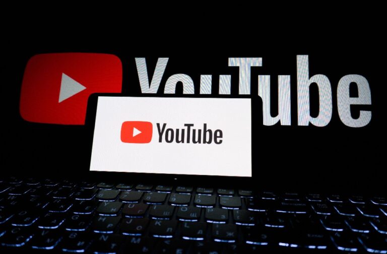 YouTube eating disorder content still reaching teens Close-up of YouTube logo displayed on a laptop screen in a dark environment