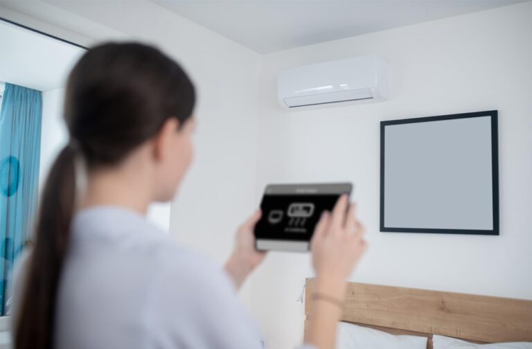 Air conditioning becomes key priority for UK homebuyers A woman controlling the air conditioning at home