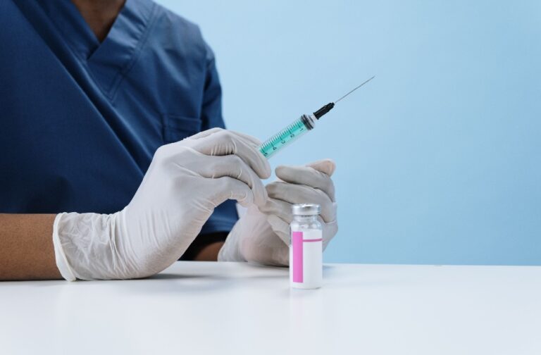 Australia to deploy bird flu vaccine plan for native birds Close-up of a healthcare professional filling a syringe with vaccine from a vial.