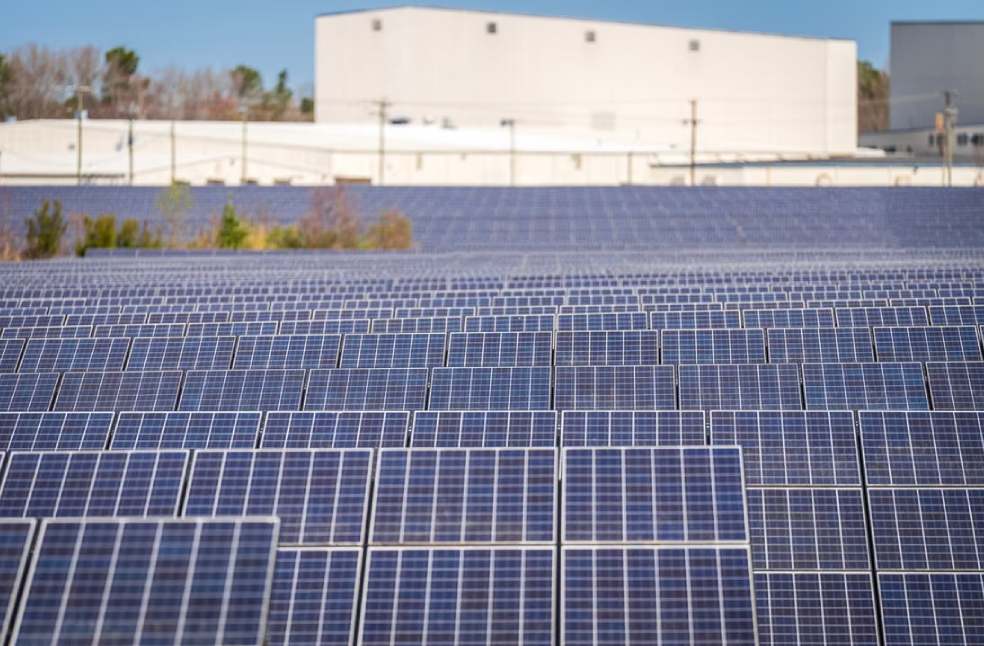 A large solar farm with photovoltaic panels generating renewable energy outdoors