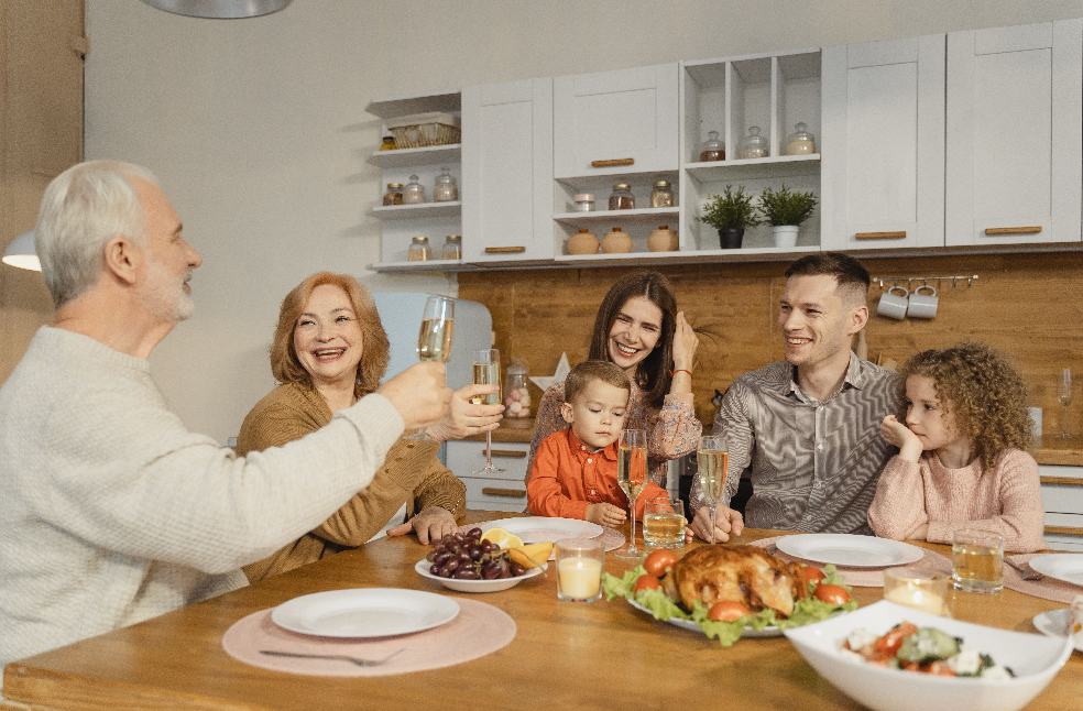 A joyful family gathering at home, celebrating Thanksgiving with food and smiles