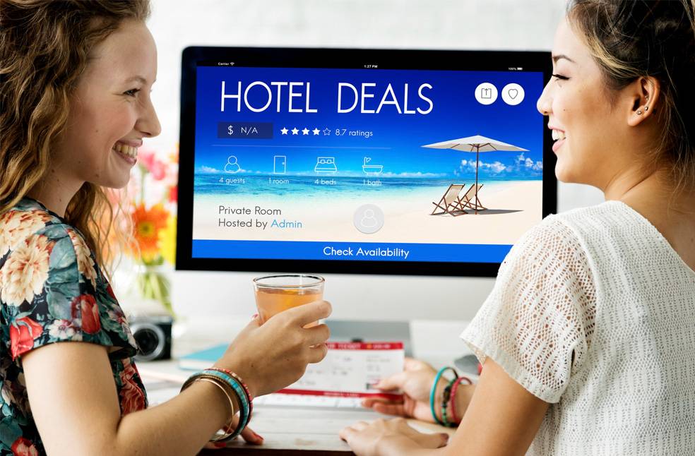 2 women looking at a hotel booking website
