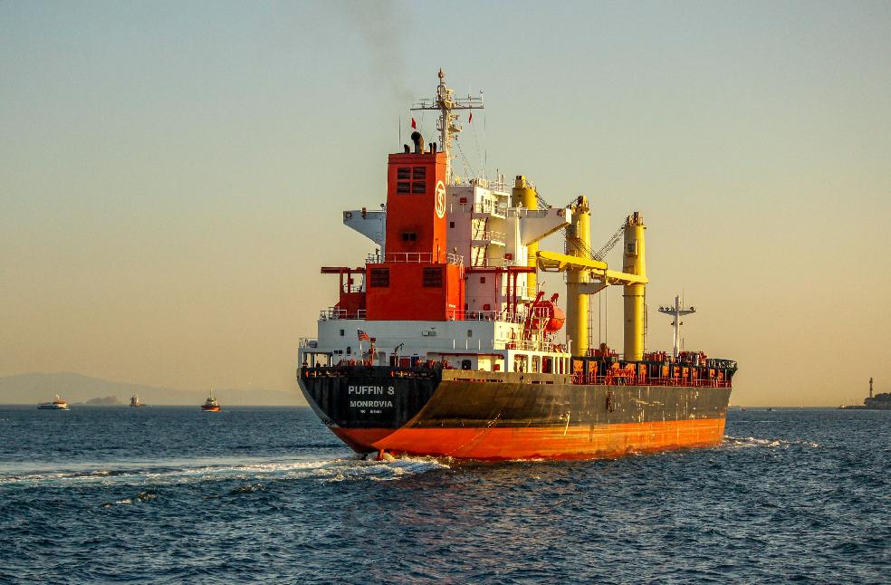 A vibrant container ship navigating the Bosphorus Strait, Istanbul during sunset, enhancing the maritime scenery