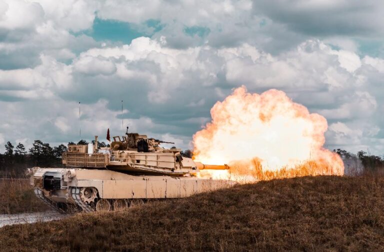 Taiwan war games review defence and mobile internet control A military tank firing during a field exercise, showcasing its immense power and precision.