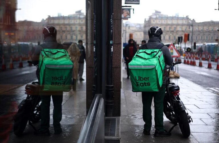 Australia sets new minimum pay for gig delivery drivers Uber Eats courier on motorbike