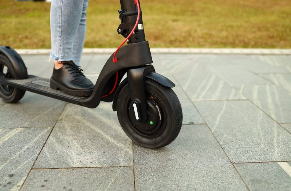 Boy's feet on a e-scooter