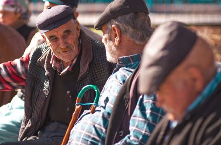 Germany’s ageing population drives social spending to record high A group of senior men with hats talk and relax on a sunny day