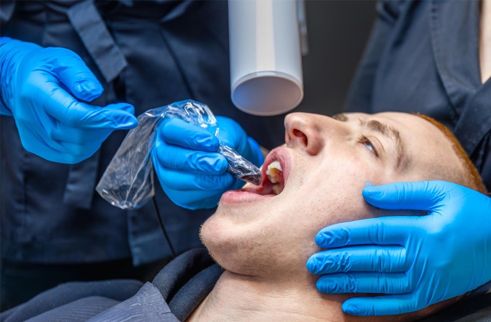 Male patient lying in a chair for dental treatment 