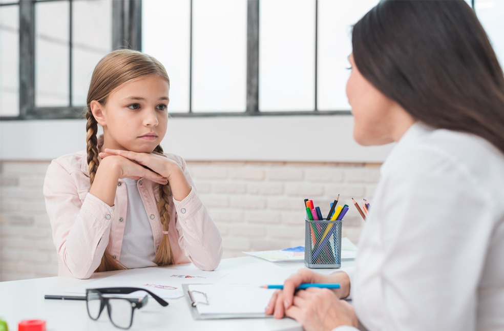 A therapist talking to a child