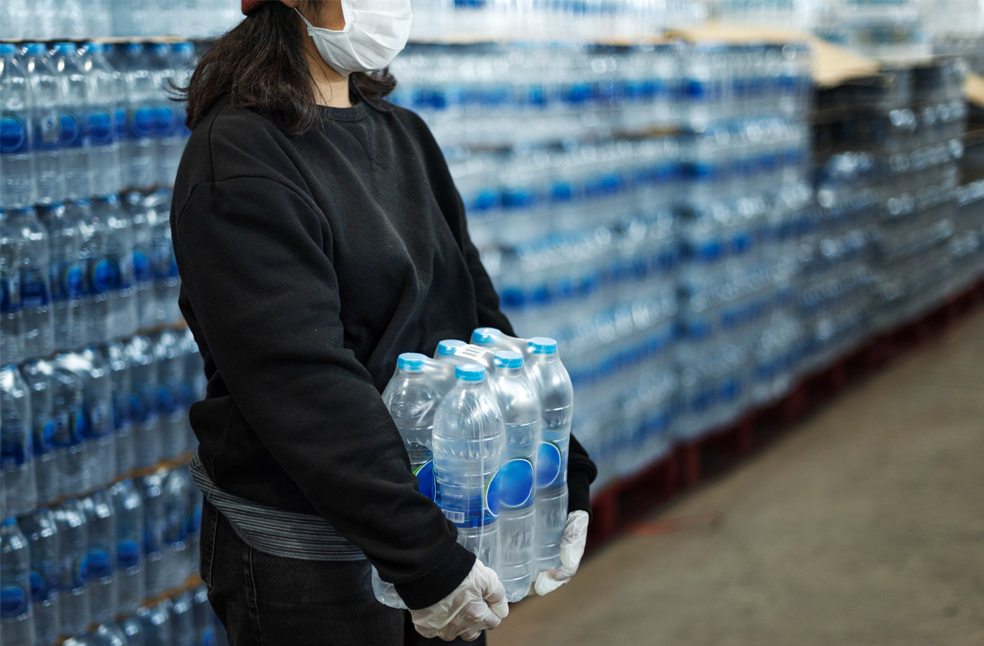 A woman buying water from a shop