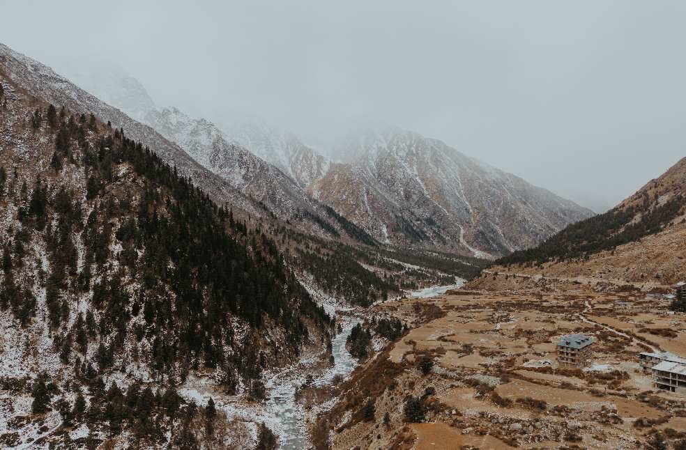 Breathtaking aerial view of snow-dusted Himalayan mountains and valley in Marango Rangarik, Himachal Pradesh, India.