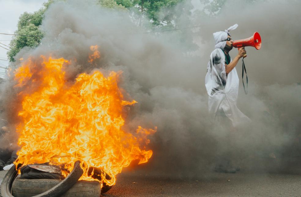 Protest scene with flames