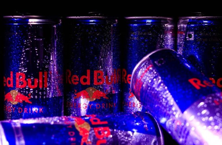India court overturns ban on Red Bull’s ‘energy drink’ label Close-up of Red Bull cans with water droplets, showcasing a refreshing and energetic vibe