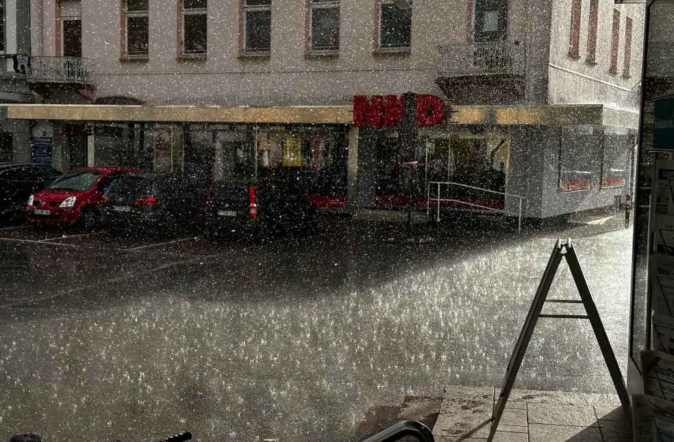 Rain falls on a city street 