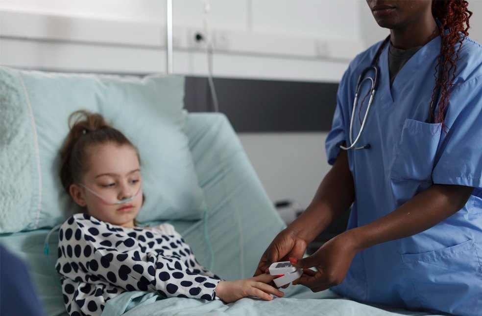 A doctor checking a sick child in the hospital