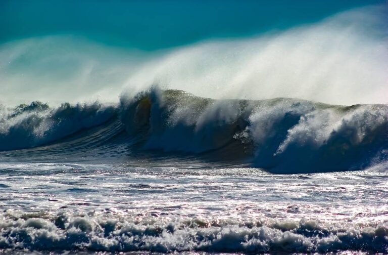 Hurricane Isaias prompts flood warnings across Florida Captivating image of a powerful ocean wave crashing with mist under a clear blue sky.