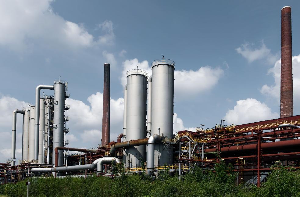 Historic industrial architecture at Zollverein Coal Mine, Essen, Germany, showcasing iconic smokestacks.