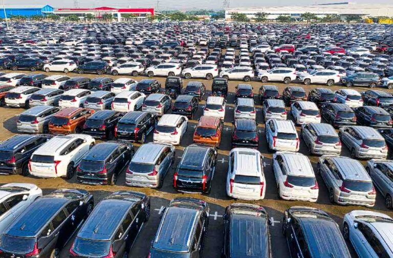 China, EU discuss fairer terms for hybrid vehicle exports Aerial view of a large car lot with parked vehicles in Bekasi Regency, West Java.