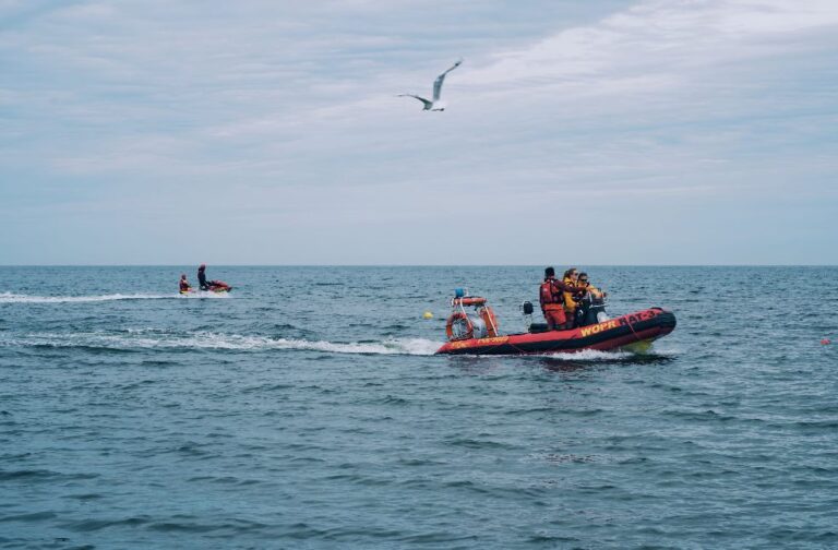 US Coast Guard ends search for 6 missing plane passengers People enjoying motorboat rides and jet ski on the open sea under a cloudy sky.