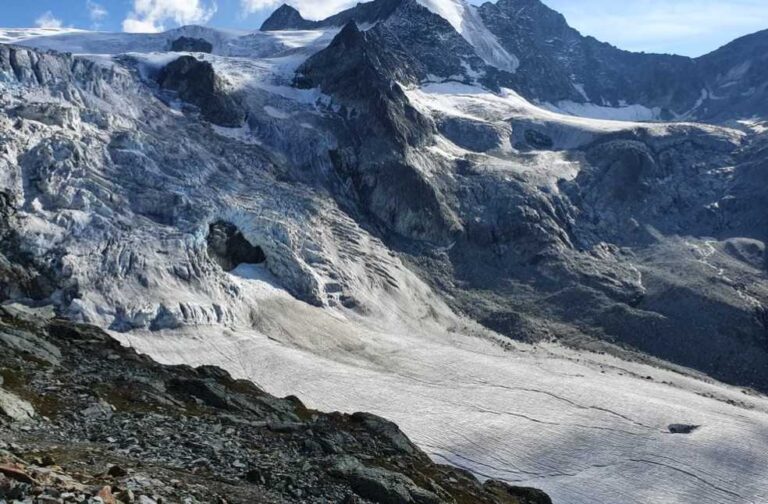 Record heatwave drives major ice loss across Swiss glaciers Stunning alpine glacier scene in Anniviers, Switzerland, showcasing rugged mountain terrain and icy peaks