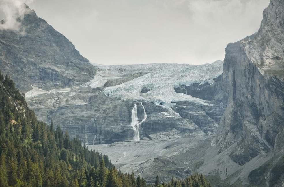 Breathtaking landscape of the Swiss Alps with glaciers and lush forests during summer