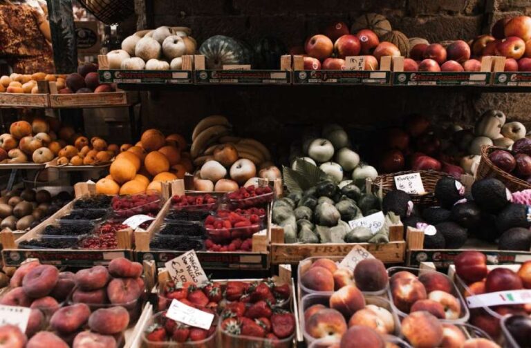 UK food system faces growing threats as experts demand action Vibrant assortment of fresh organic fruits at an outdoor market stall.