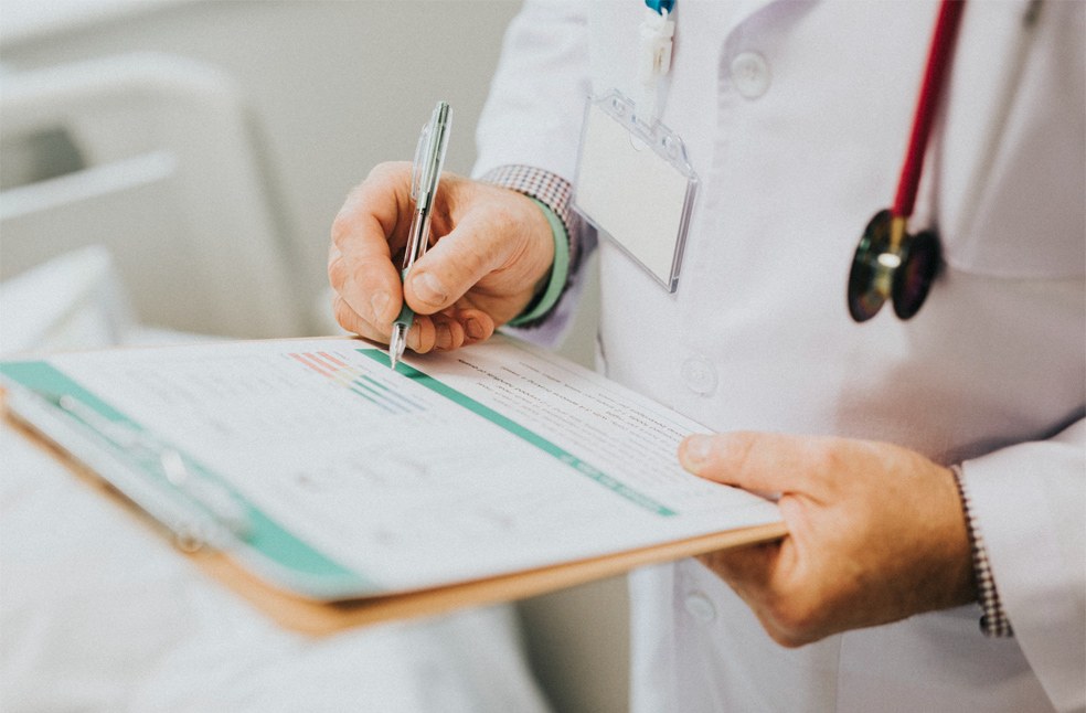 Close-up of a doctor noting down the diagnosis