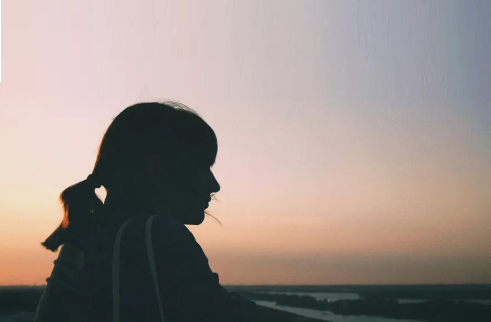Silhouette of a woman at sunset
